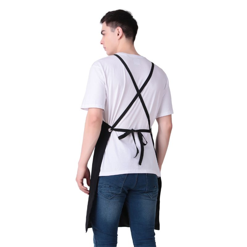 Person wearing a black apron over a white shirt on a white background