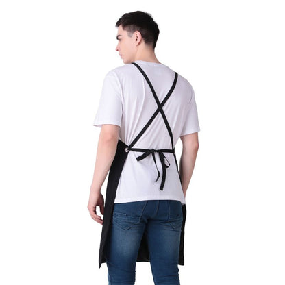 Person wearing a black apron over a white shirt on a white background