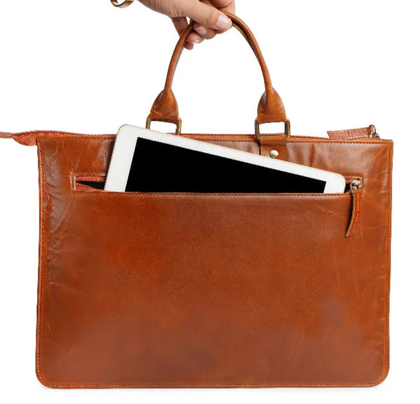 Brown leather briefcase with a tablet inside, held by a hand on a white background