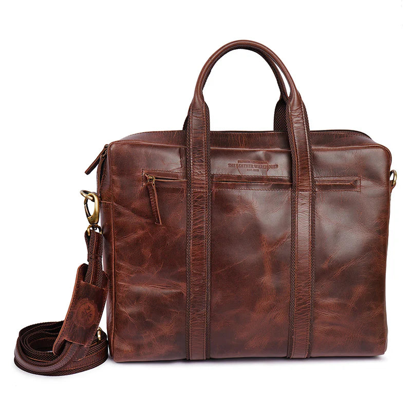 Brown leather briefcase with shoulder strap on a white background