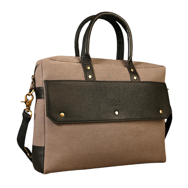 Brown and black handbag with gold accents on a white background