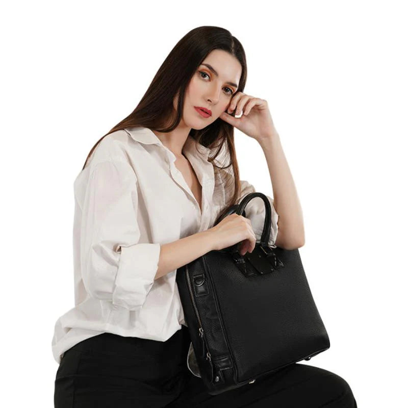 Woman holding a black handbag against a white background