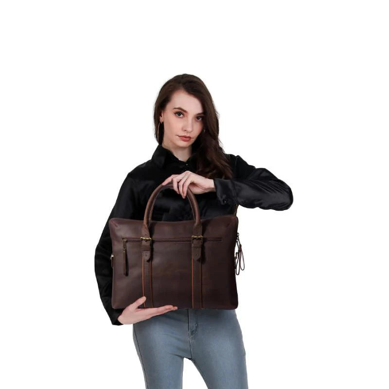 Woman holding a brown leather bag against a white background