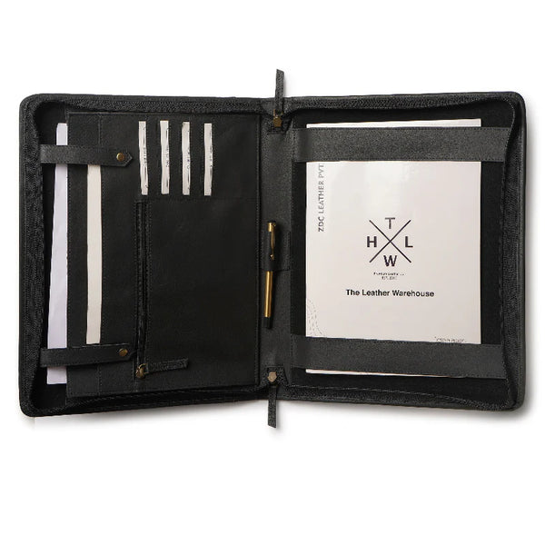 Black leather portfolio with pen holder and paper inside, featuring The Leather Warehouse logo.