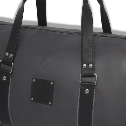 Black leather bag with straps and a visible brand logo on a white background