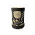 Black cylindrical container with gold floral patterns on a white background