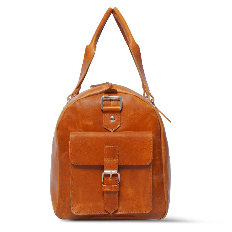 Brown leather bag with silver buckles on a white background