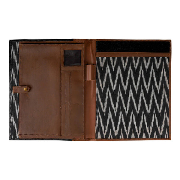 Brown leather wallet with black and white zigzag pattern on a white background