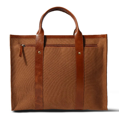 Brown tote bag with leather straps on a white background
