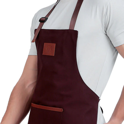 Brown apron with leather straps worn by a person on a white background