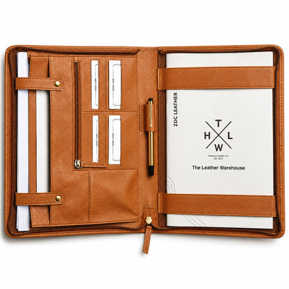 Open tan leather portfolio organizer with card slots, pen holder, zipper pocket, and document compartments