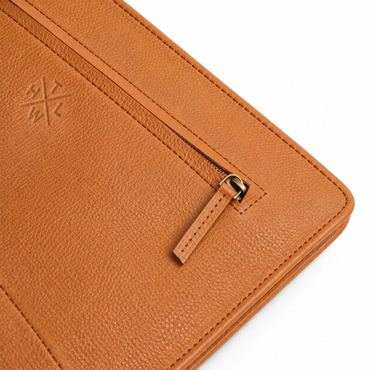 Close-up of the tan leather portfolio zipper, stitched edges, and embossed logo