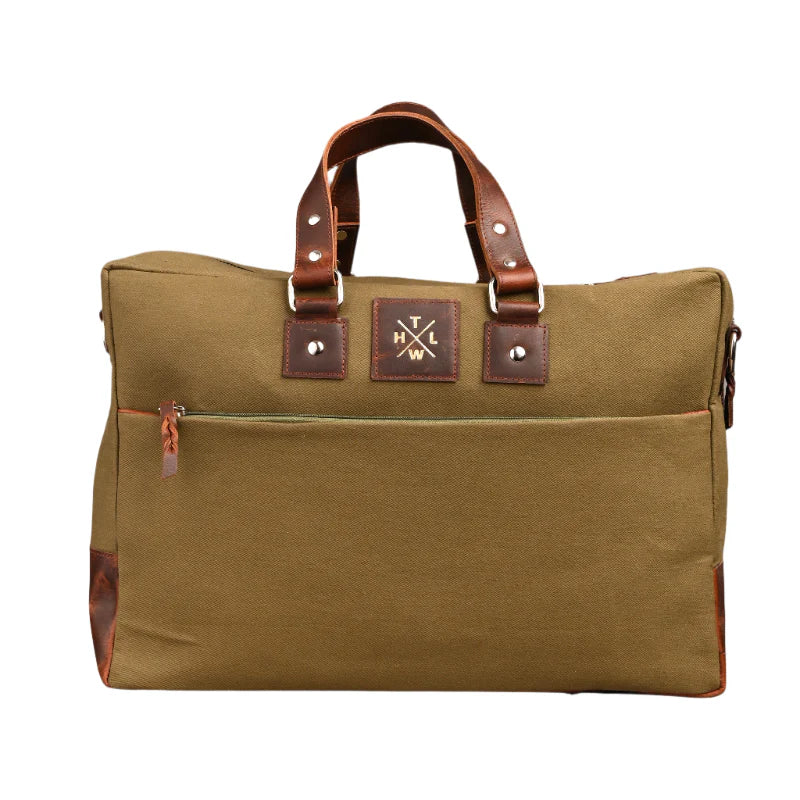 Brown canvas bag with leather handles and trim on a white background