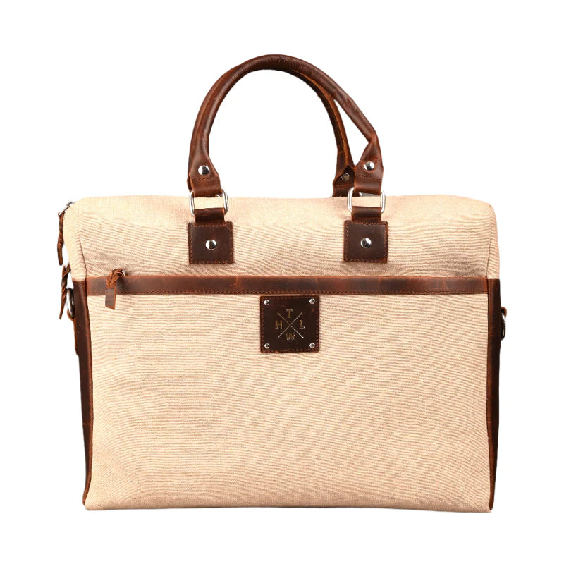 Beige bag with brown leather accents on a white background