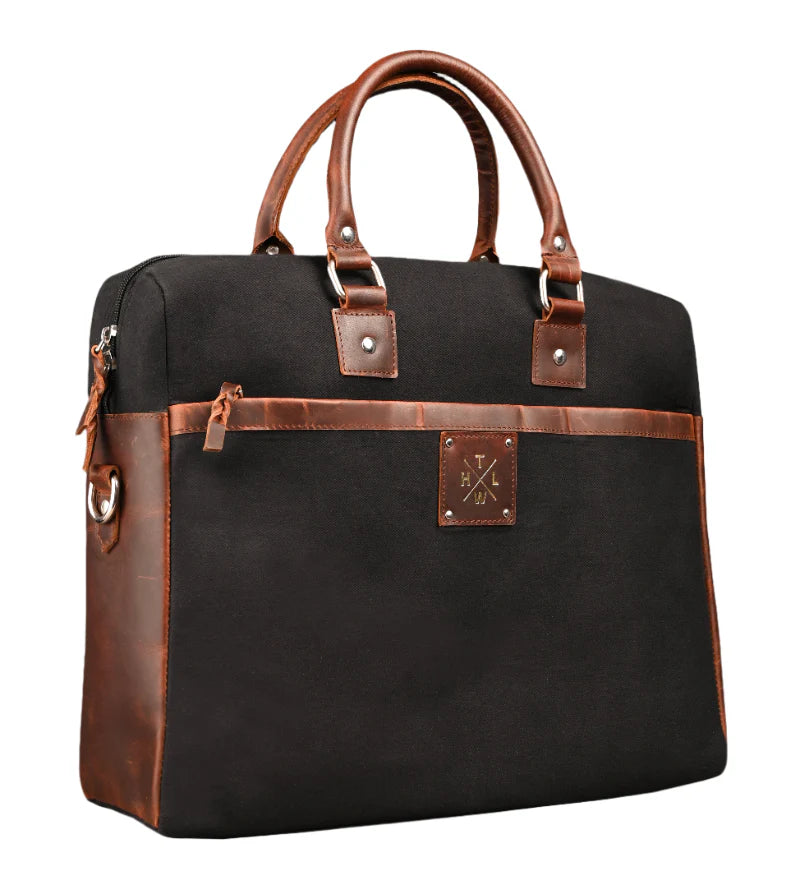 Black bag with brown leather accents on a white background