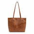 Brown leather tote bag on a white background