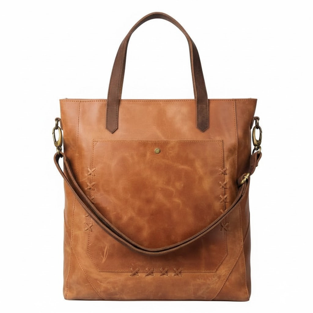 Brown leather tote bag with visible stitching on a white background