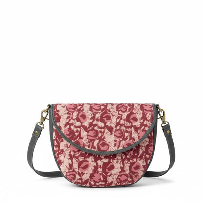 Floral patterned handbag with a strap on a white background