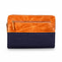 Two-toned orange and navy clutch bag on a white background
